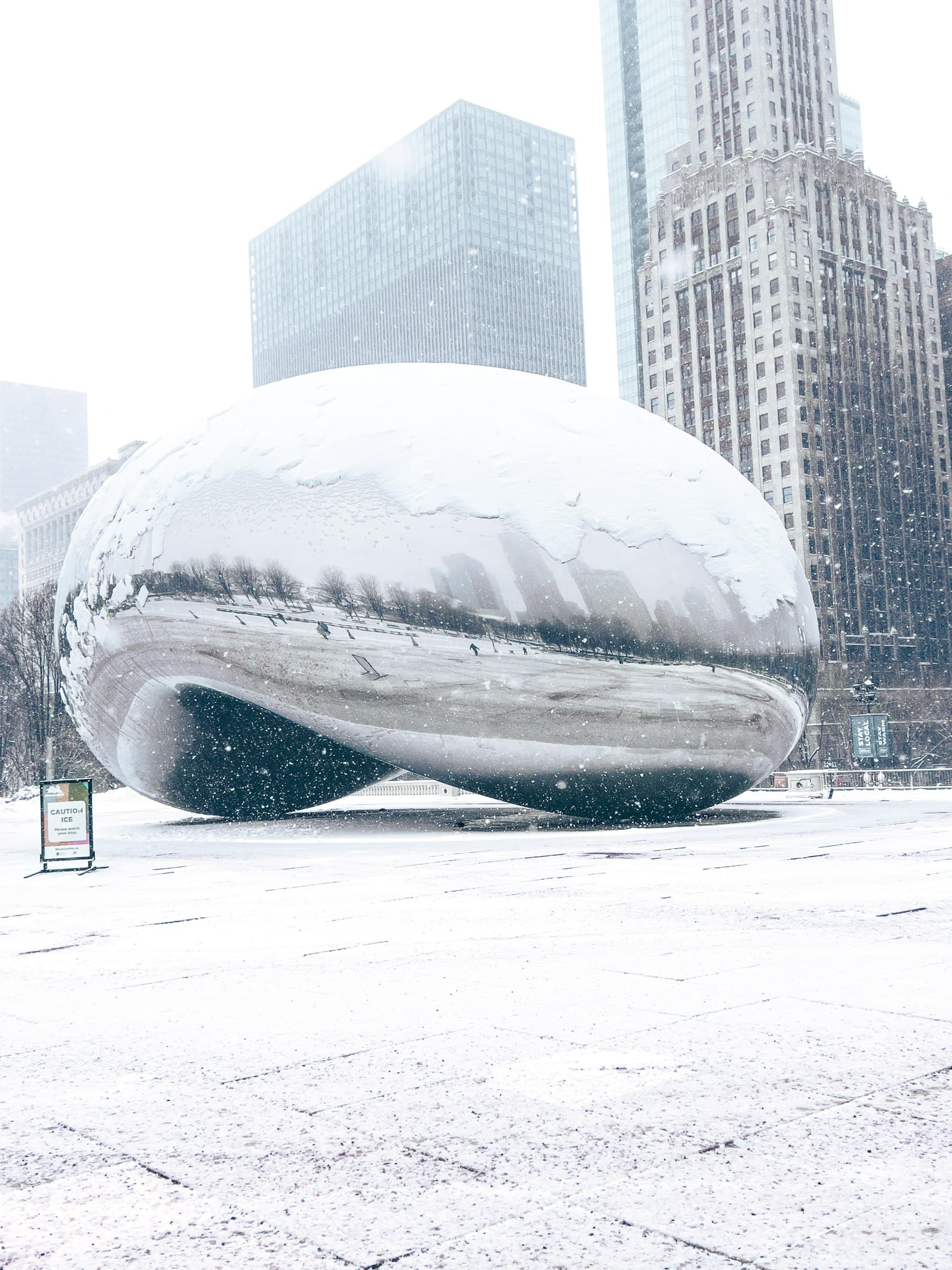 Cloud Gate sculpture (The Bean) in Chicago's Millennium Park covered in winter snow