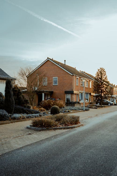 Brick residential homes on a quiet Midwest neighborhood street