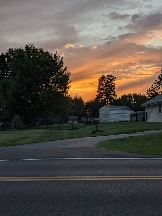 Midwest suburban neighborhood at sunset with homes and trees