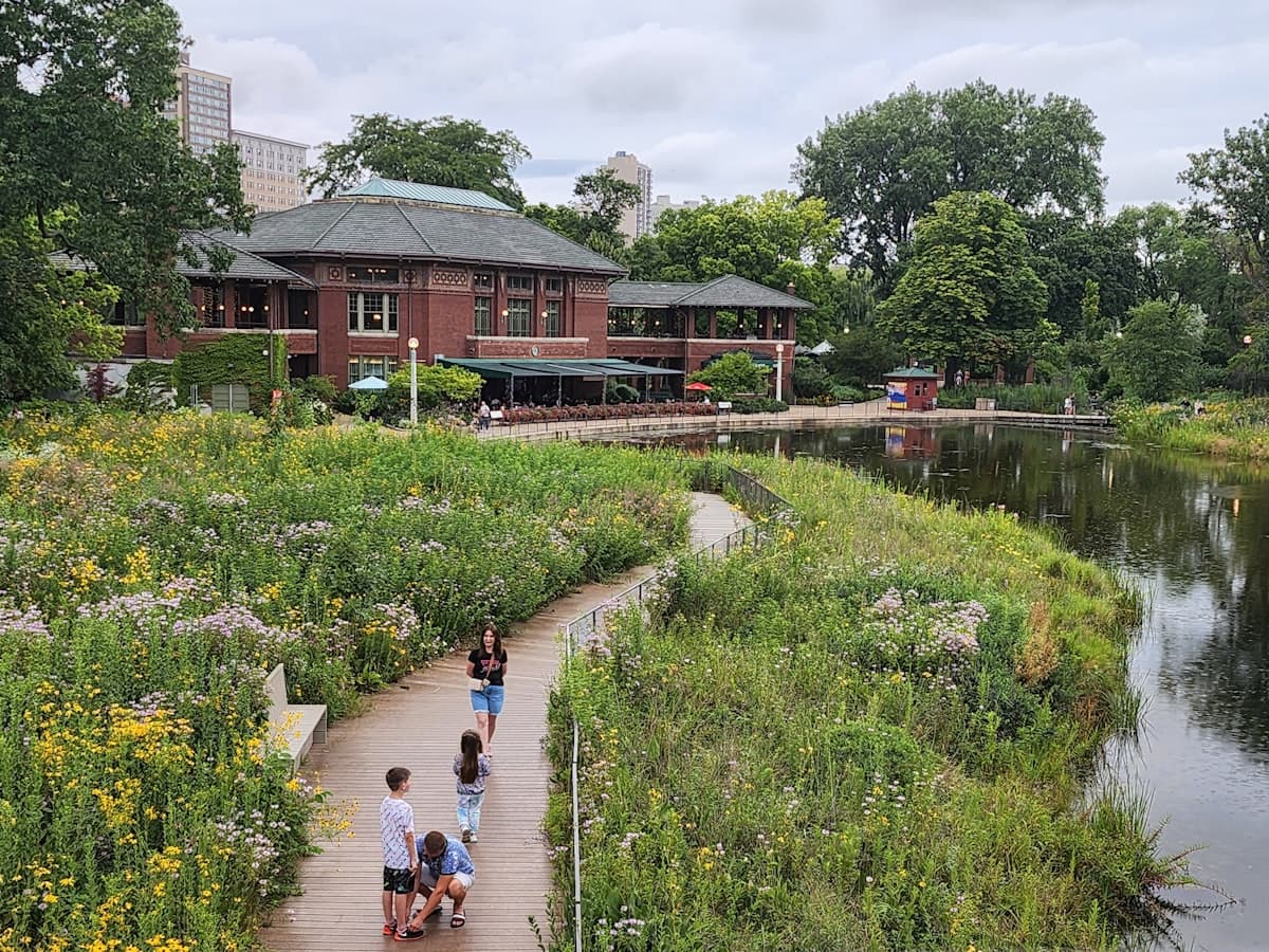 Lincoln Park Chicago with pathway, pond and historic pavilion building