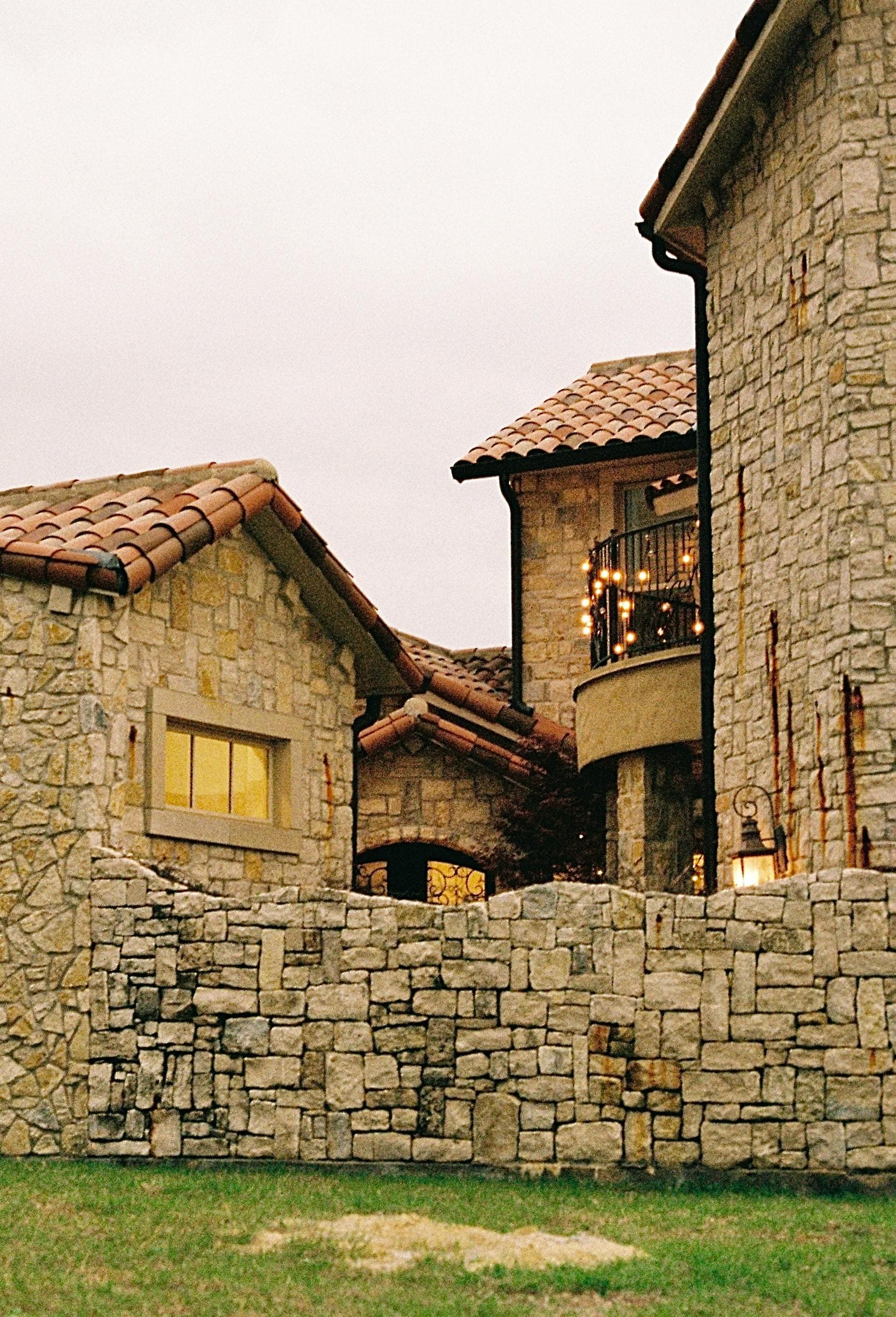 Luxury stone mansion with tile roof in Dallas Texas representing Highland Park residential area