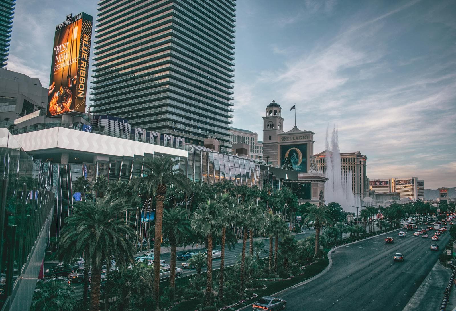Las Vegas Strip with Bellagio fountains and palm trees under desert sky