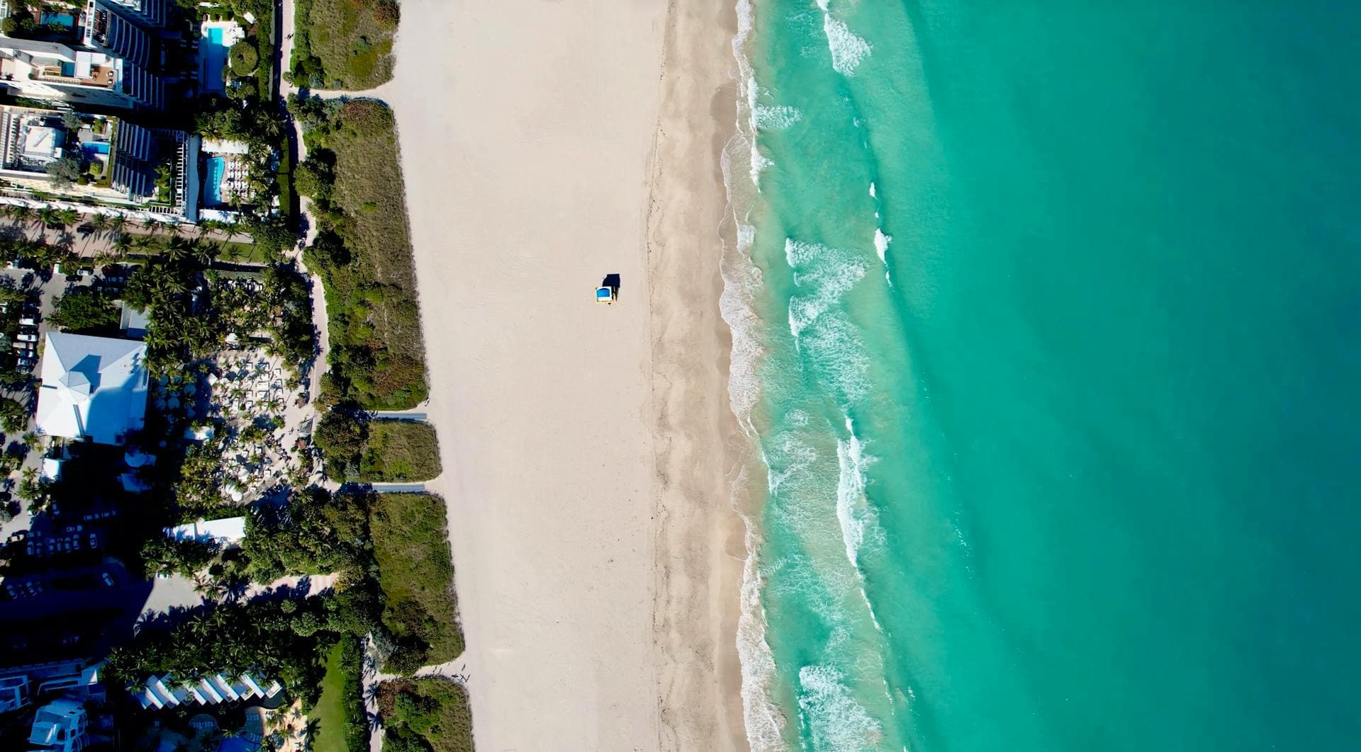 Aerial view of Miami Beach coastline with turquoise waters and sandy beach