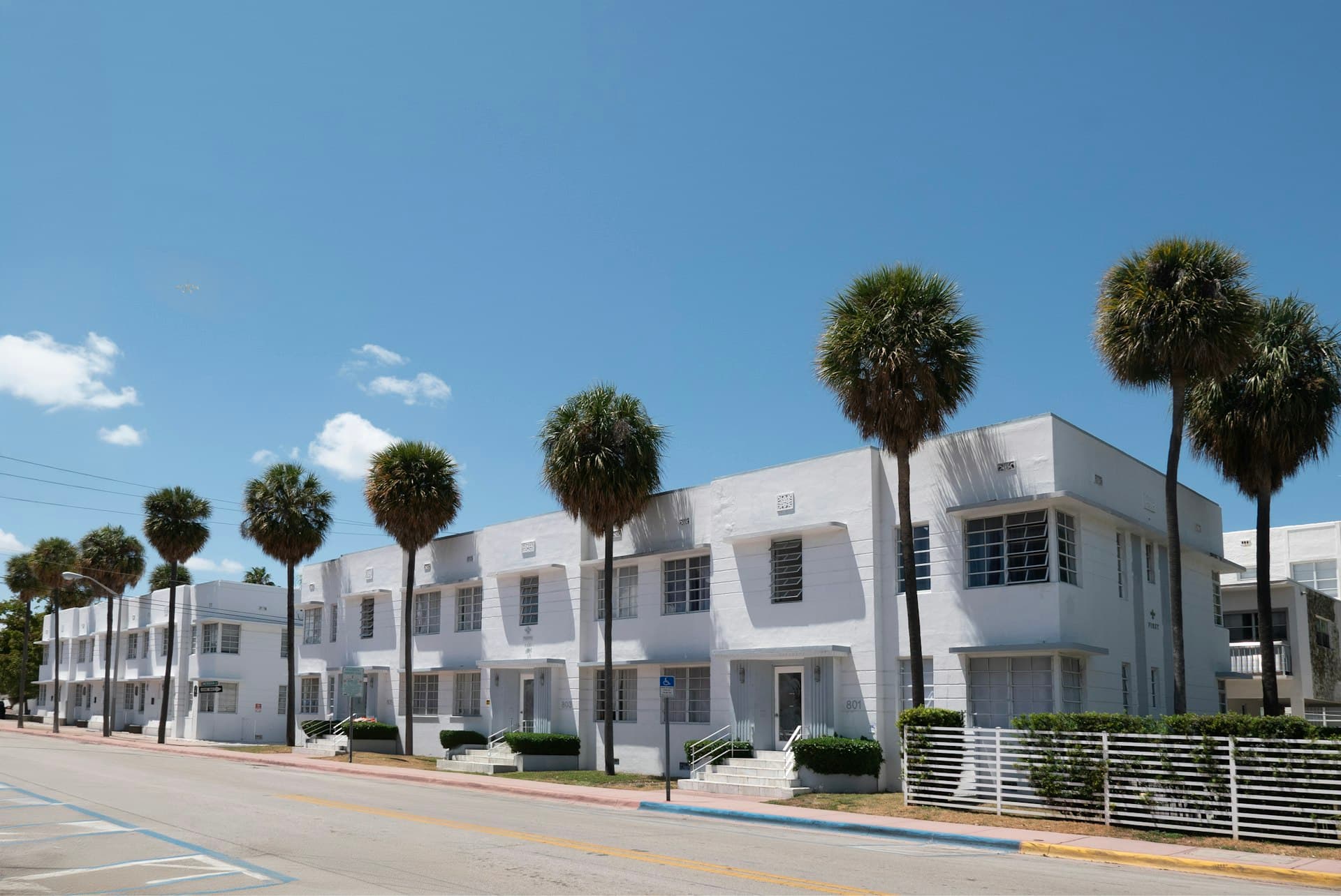 Art Deco style white buildings with palm trees in Miami Beach Florida