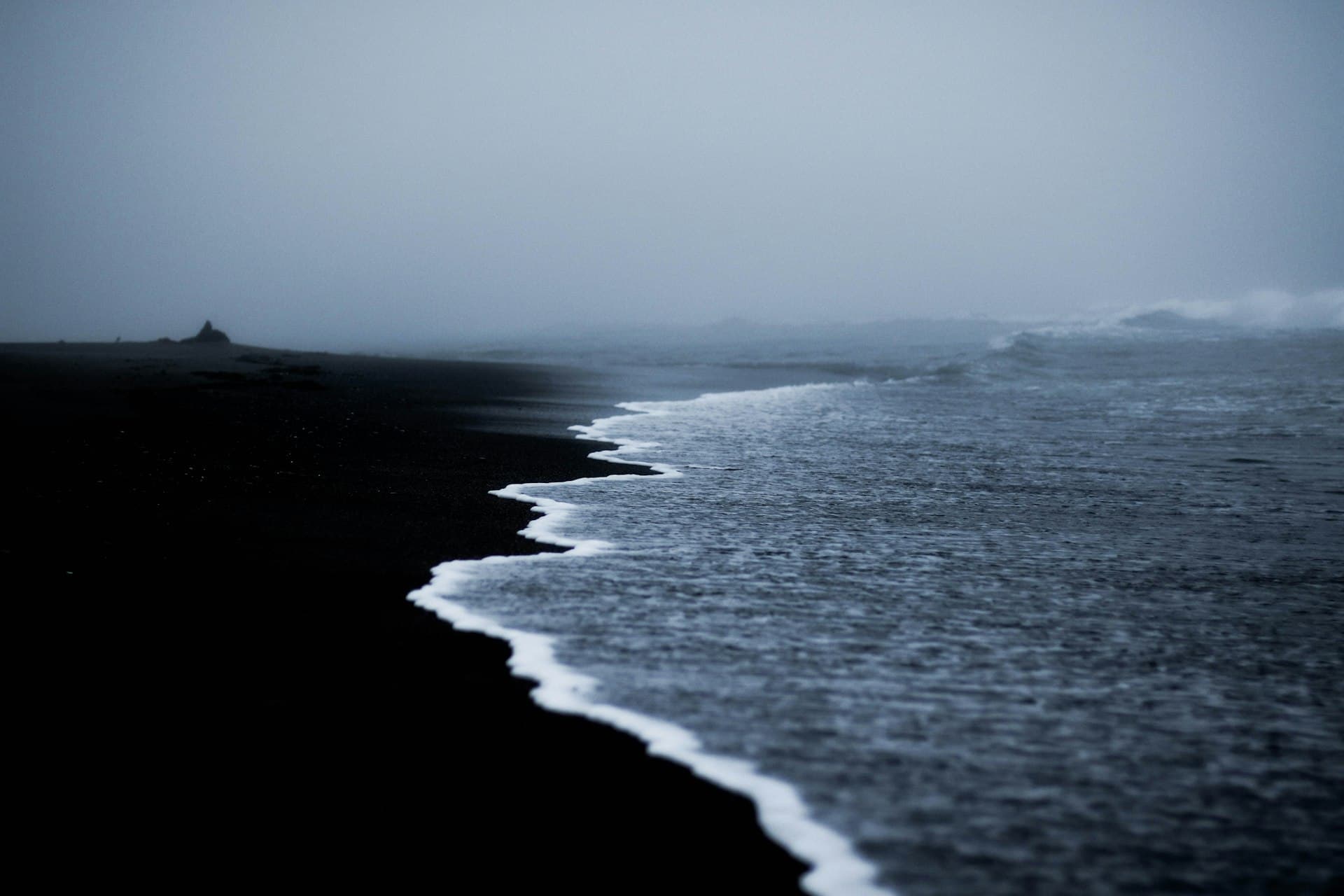 California coastal marine layer fog rolling over beach and ocean waves