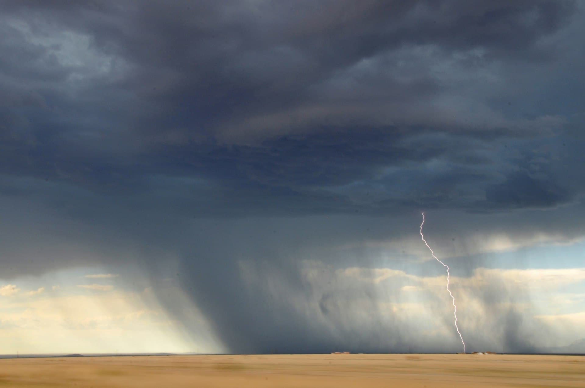 Monsoon lightning strike over desert landscape