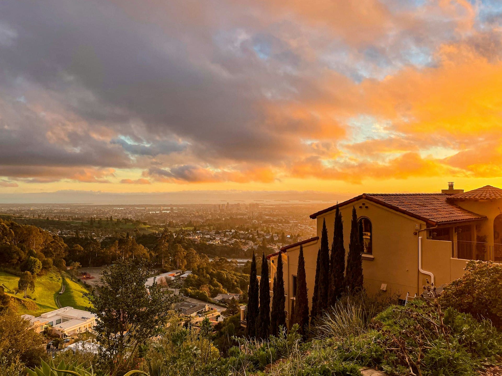 Oakland Hills home at sunset with panoramic views of the Bay Area flatlands below