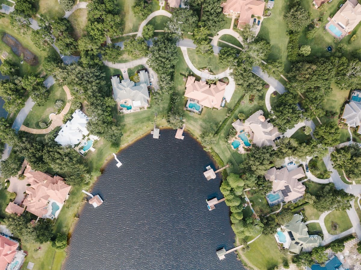 Aerial view of Florida lakefront homes with pools in residential neighborhood