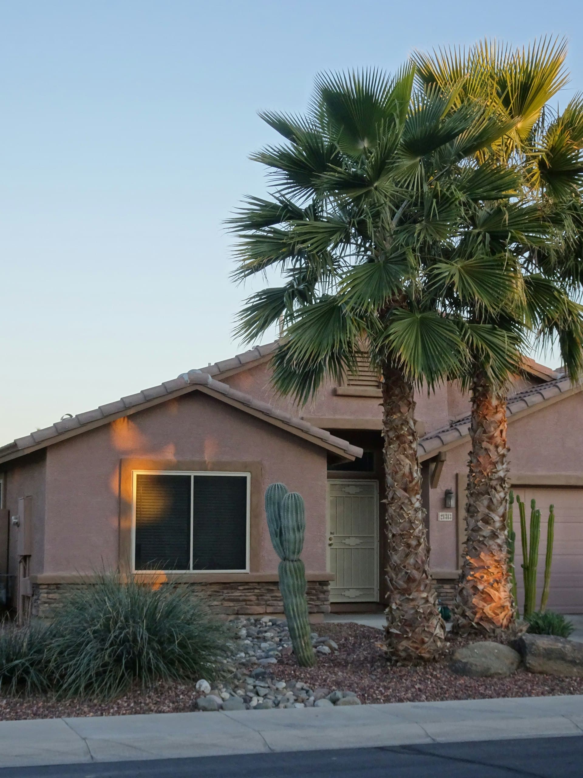 Typical Phoenix Arizona home with desert landscaping palm tree and stucco exterior