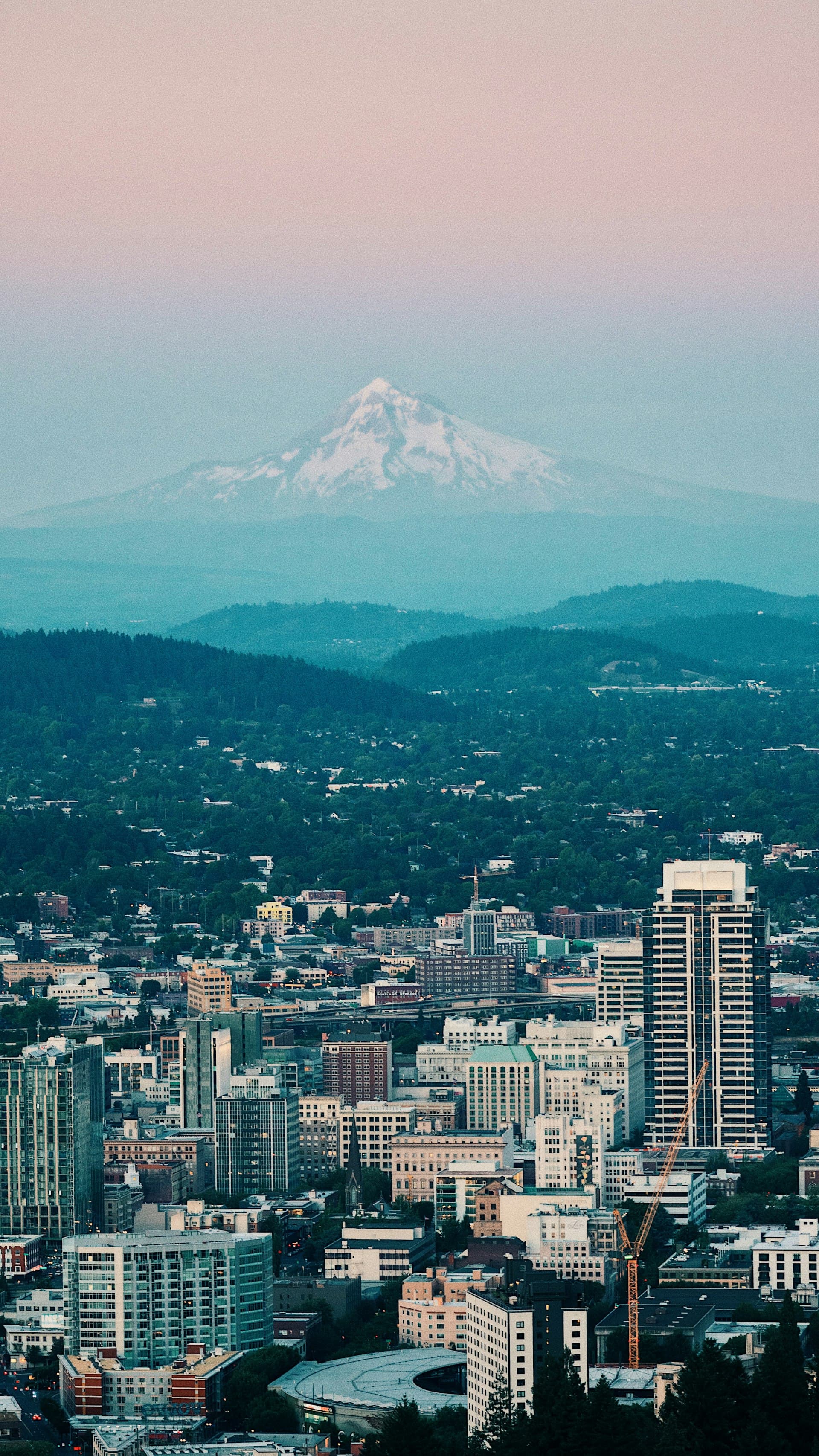 Aerial view of Portland downtown at dusk with Mount Hood in the background