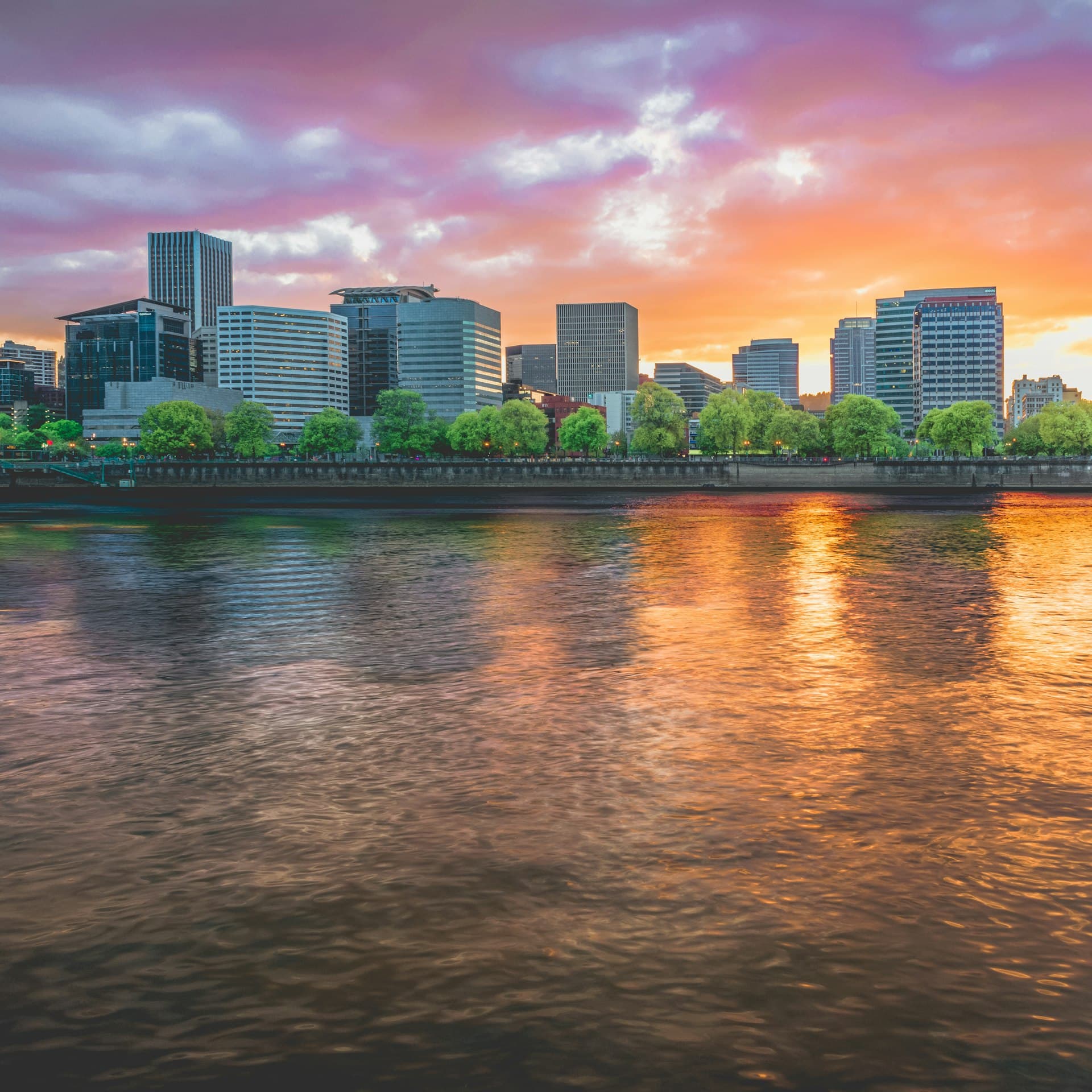Portland waterfront skyline at sunset with dramatic orange and purple sky