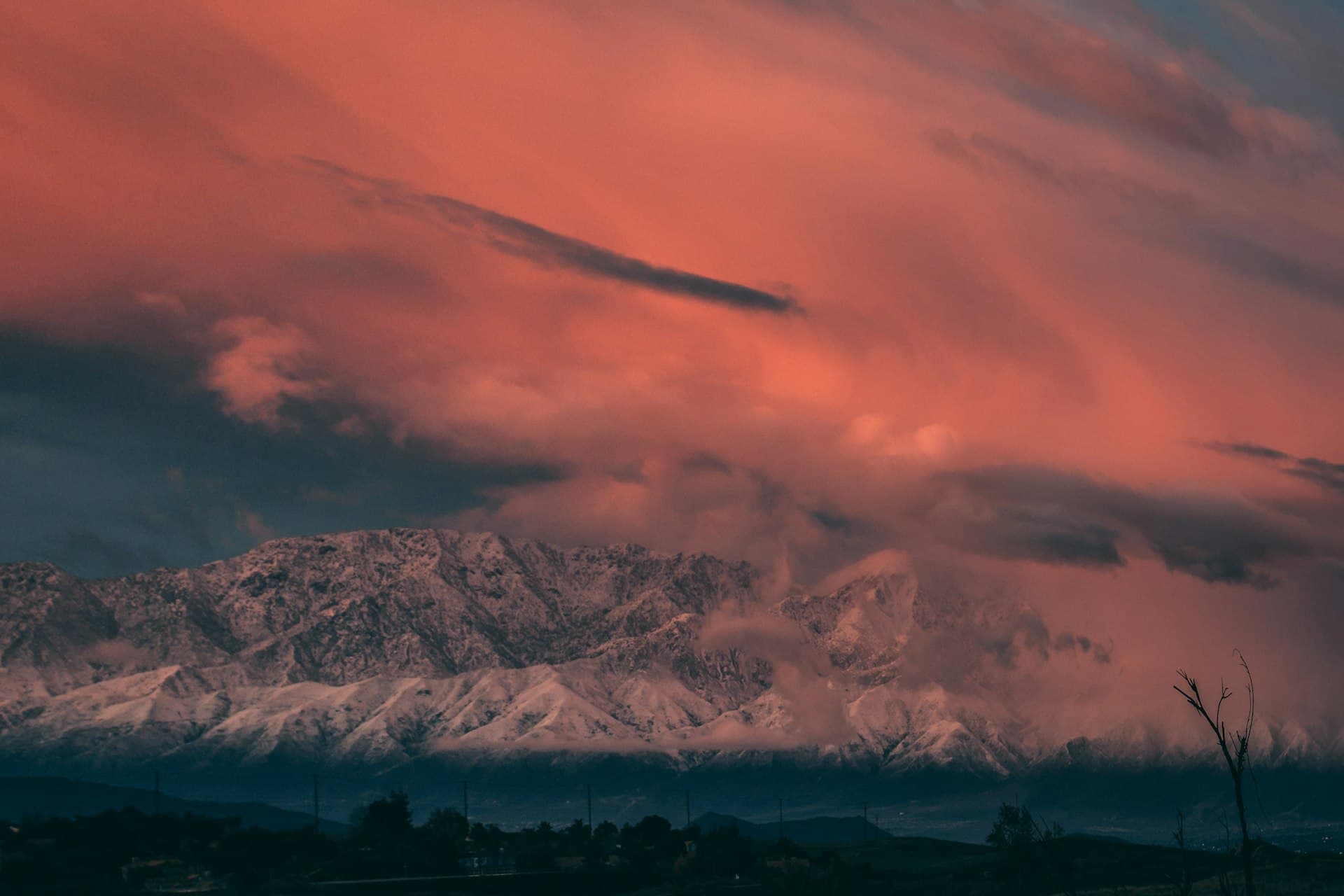 Dramatic sunset over snow-capped mountains viewed from Canyon Crest area of Riverside California