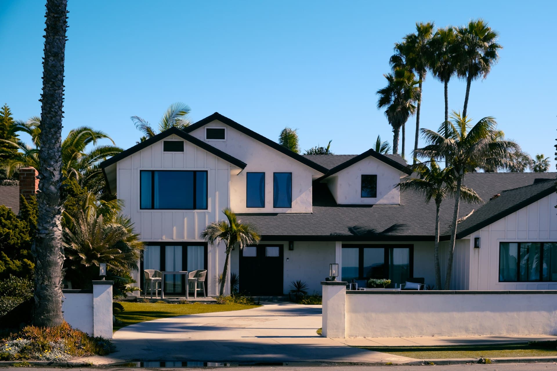 Beautiful white San Diego home with palm trees