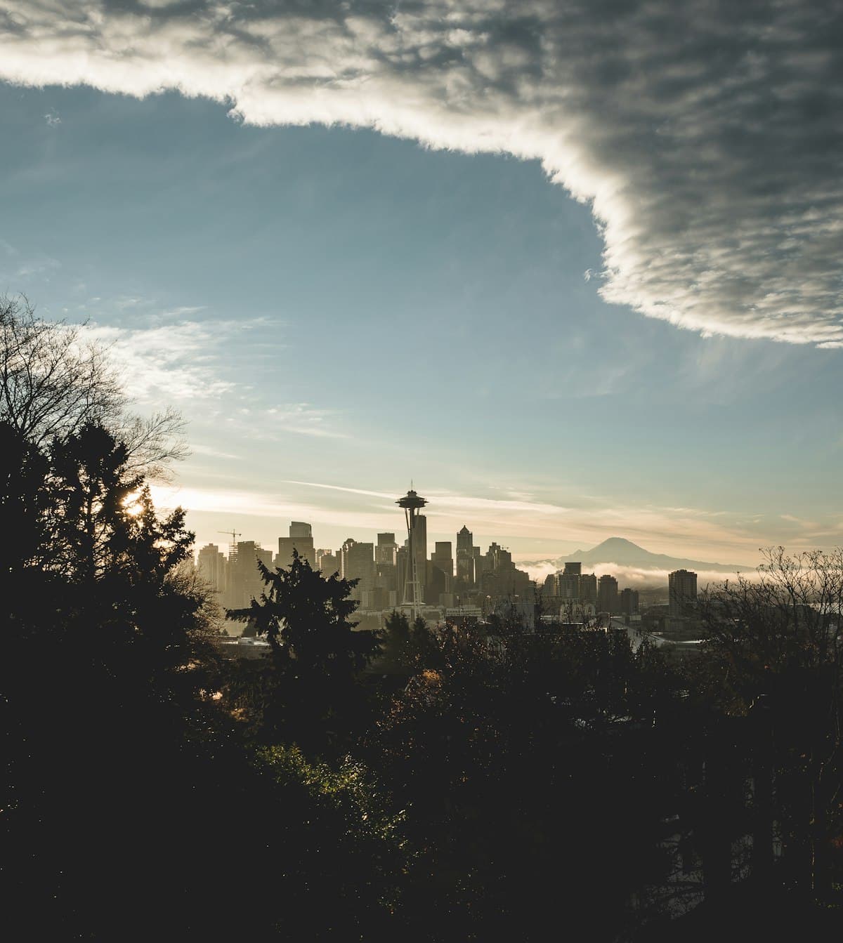 Seattle skyline with dramatic Pacific Northwest clouds and Mount Rainier