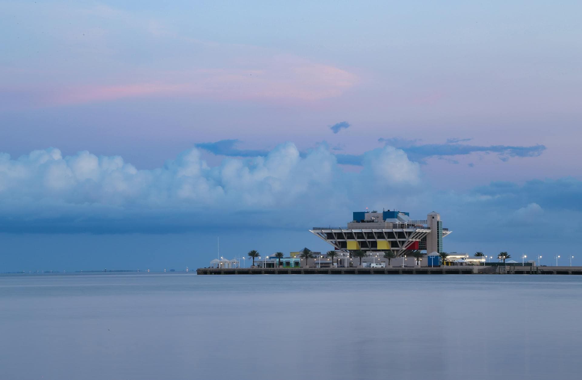 St. Pete Pier at twilight with calm water reflections and dramatic clouds over Tampa Bay