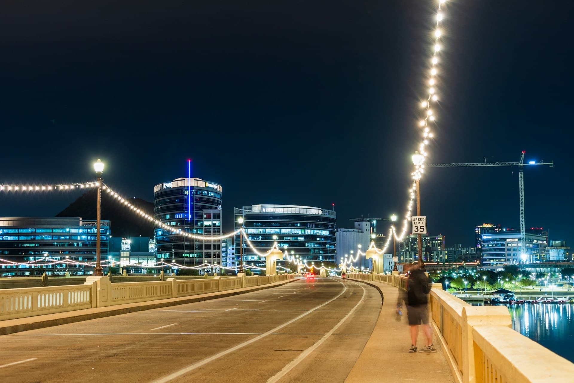 Downtown Tempe Mill Avenue bridge at night with city lights and Tempe Town Lake